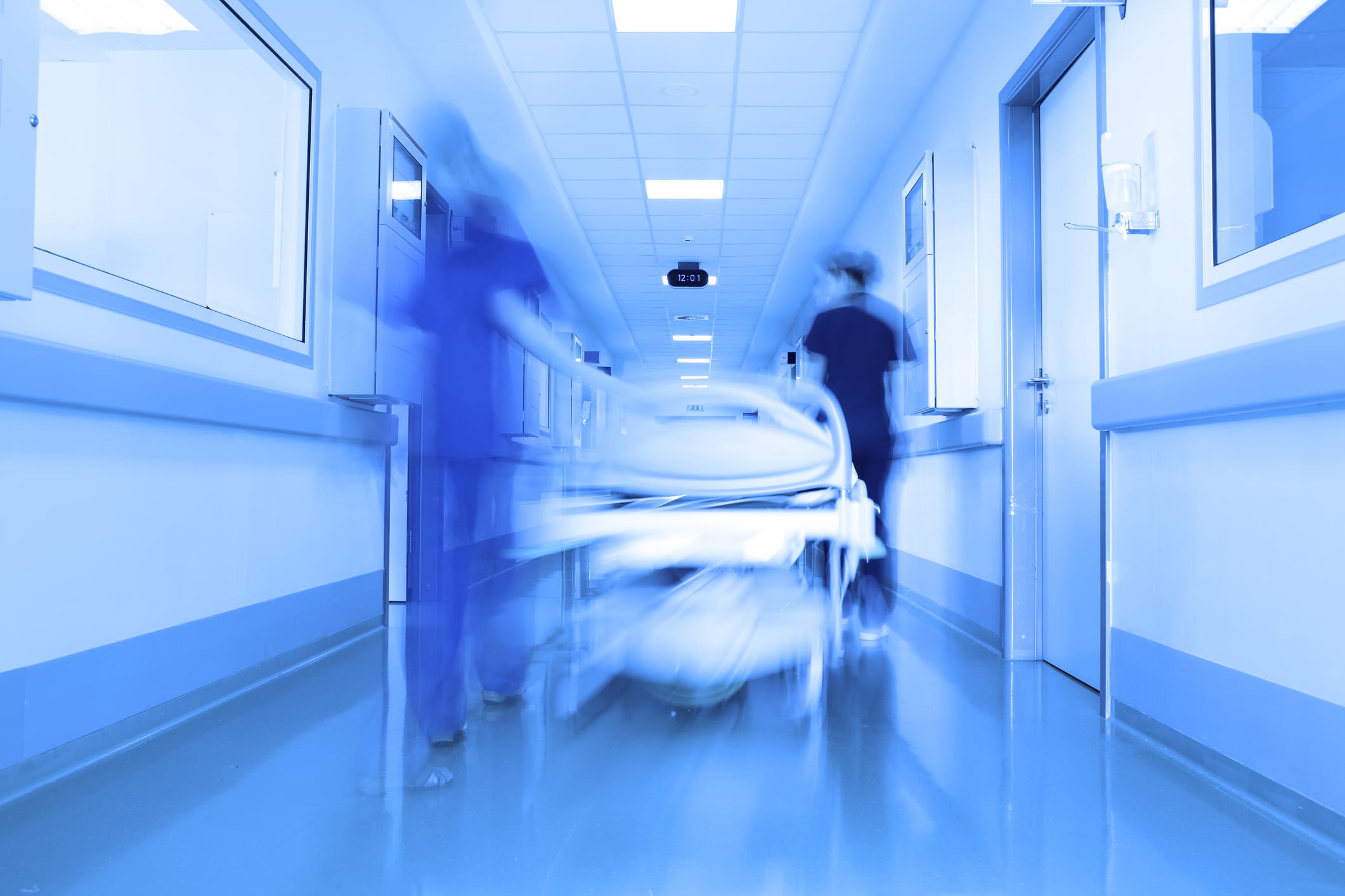 A blurry photo of a hospital room with two men in it.