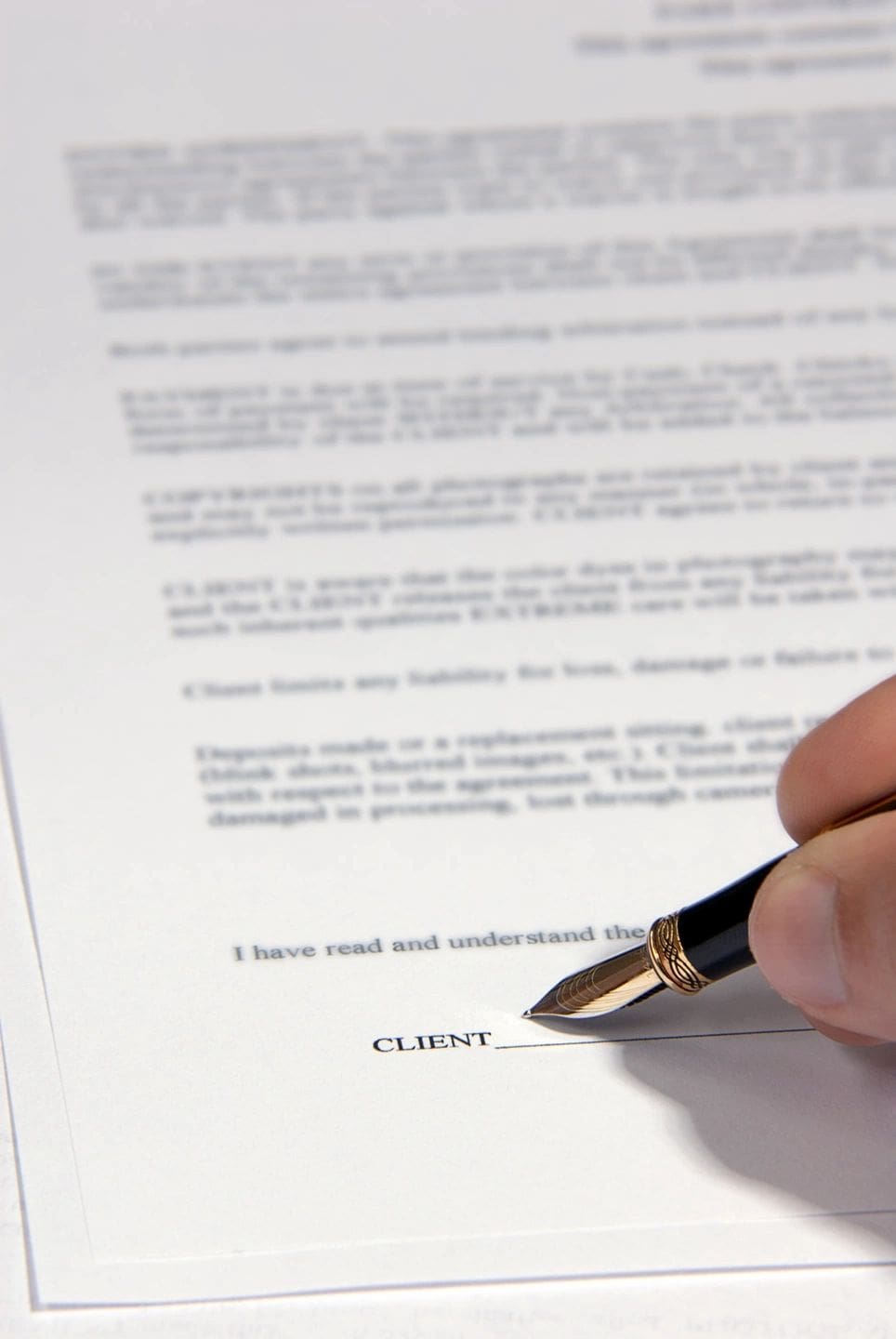 fm=f_121166 A person is writing on top of a paper.